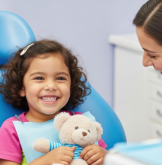 Little girl smiling in the dentist’s chair
